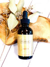 Butter Me Up Organics hair oil with lavender and rosemary essential oils on rustic background