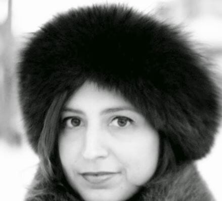 Person wearing a fur hat in black and white