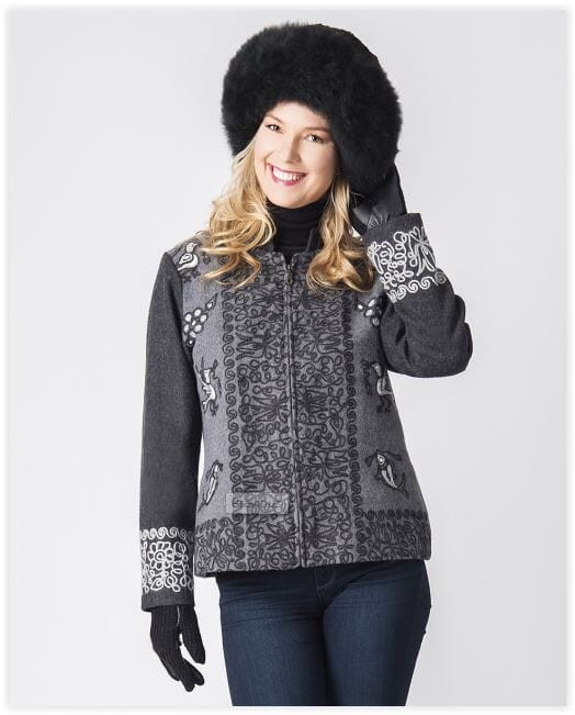 Woman wearing a patterned jacket with fur-lined hood on a white background