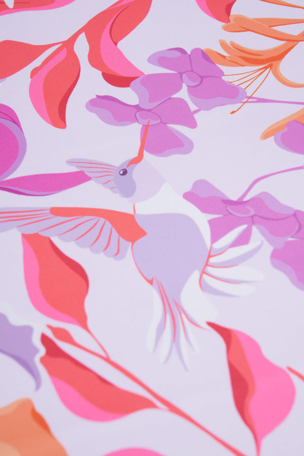 Colorful floral and bird pattern on a light purple background