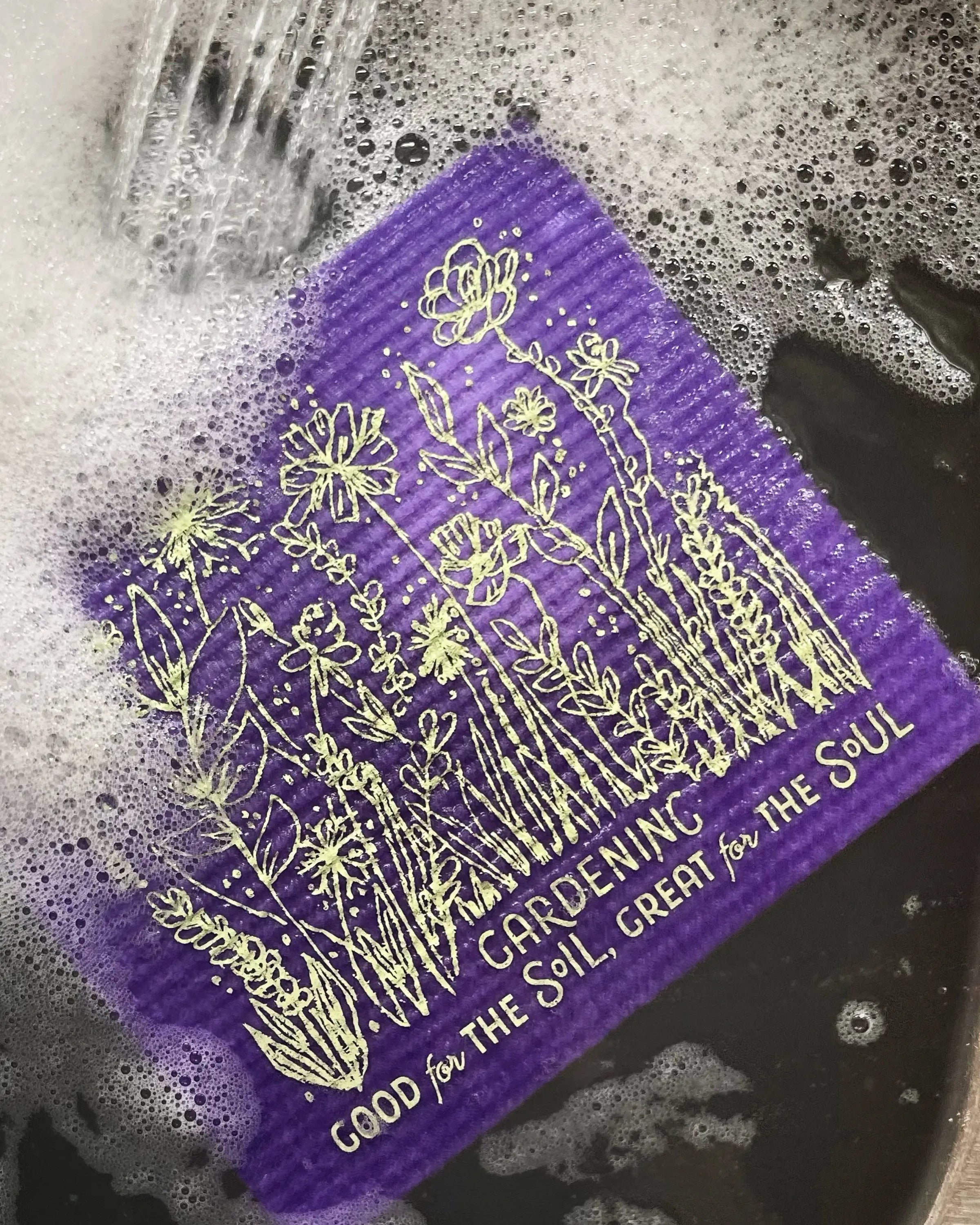 Close-up of Good for the Soil Great for the Soul eco-friendly Swedish dishcloth in purple