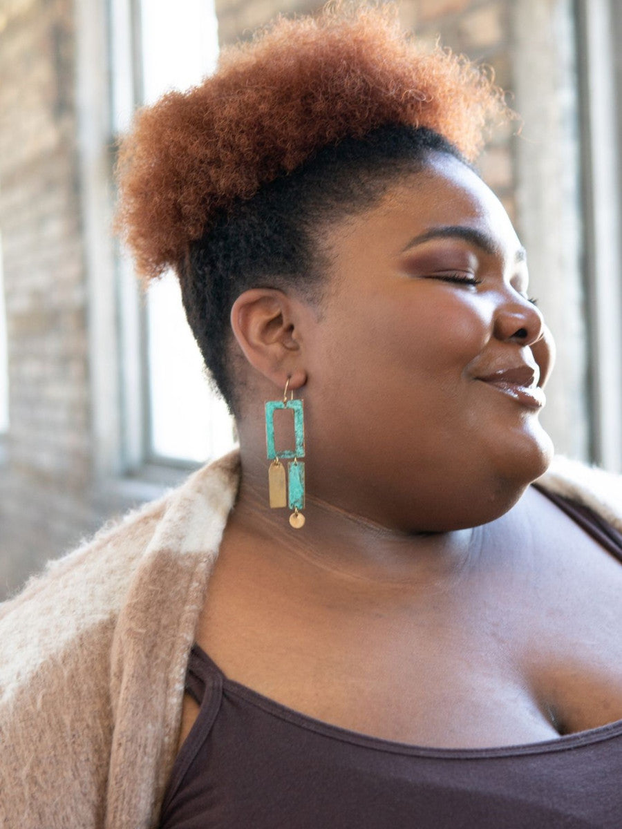 Close-up of recycled brass and copper patina frame earrings by Fair Anita Chile Collection