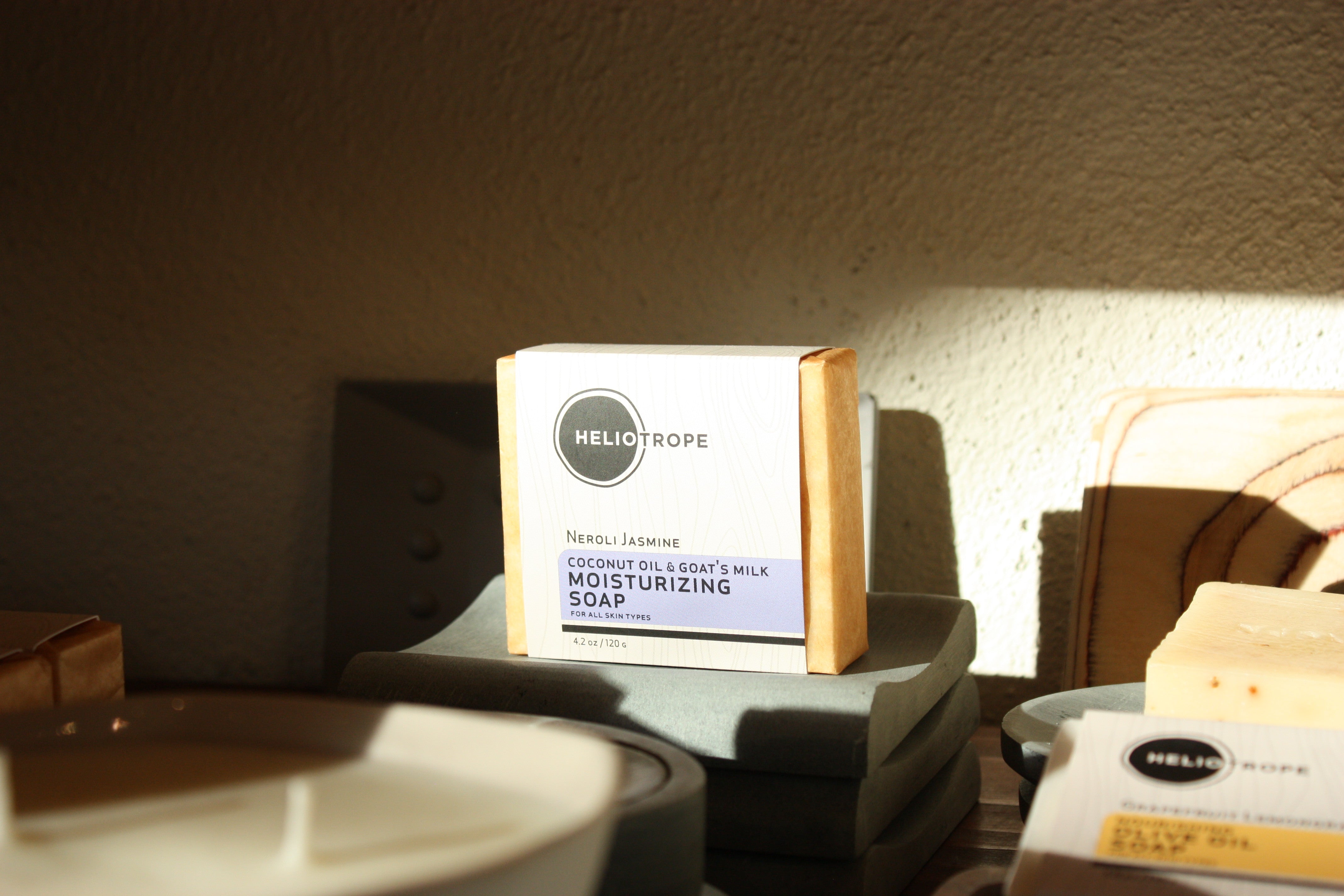 Heliotrope SF Neroli Jasmine goat's milk soap bar with natural essential oil scent on a white background