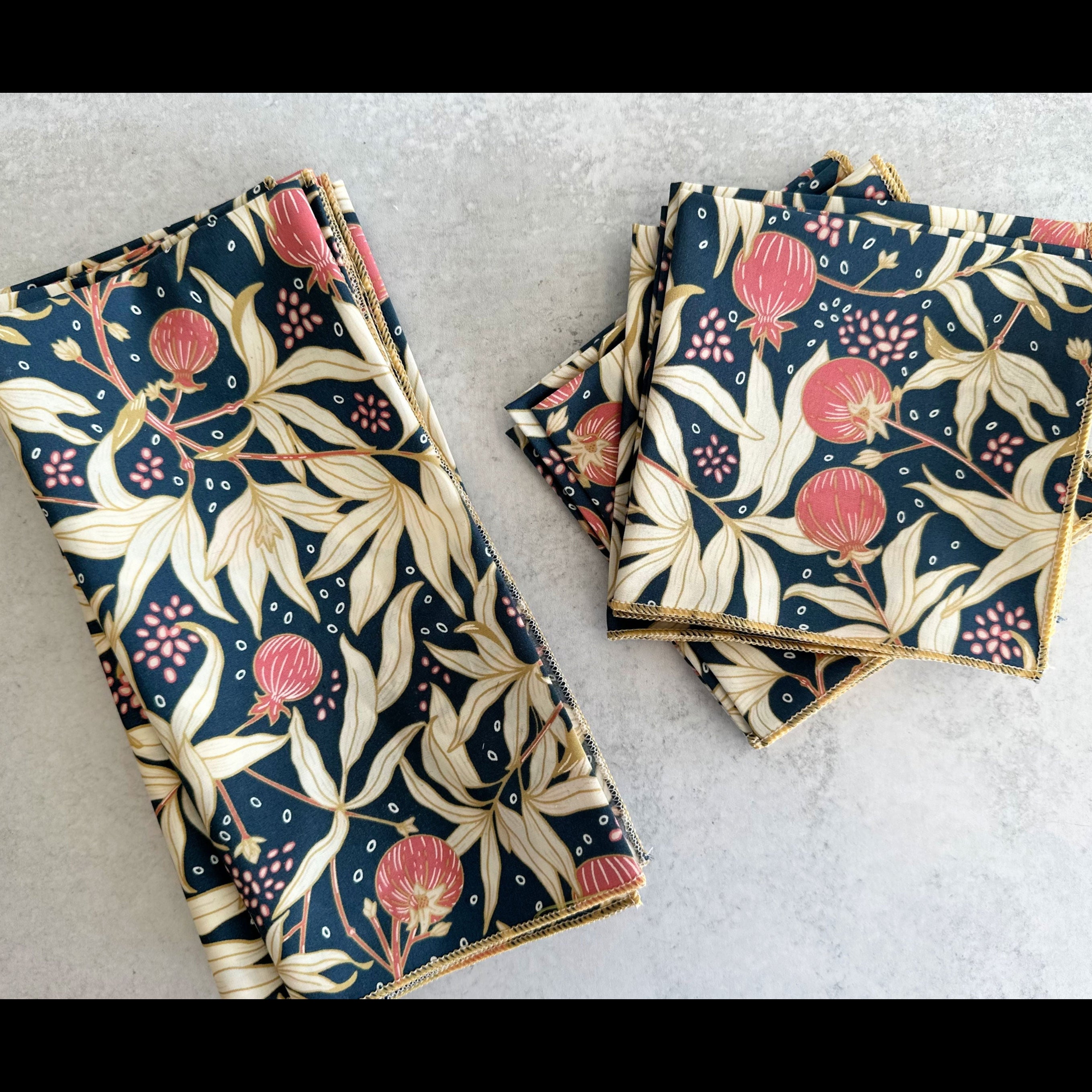 Gooseberry cotton cloth napkins folded on a table — navy blue botanical print by Dot and Army