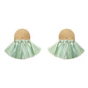 Pair of earrings with round beige tops and green tassel bottoms on a white background