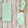 Green seersucker cloth dinner napkins set of 4 displayed on a wooden table