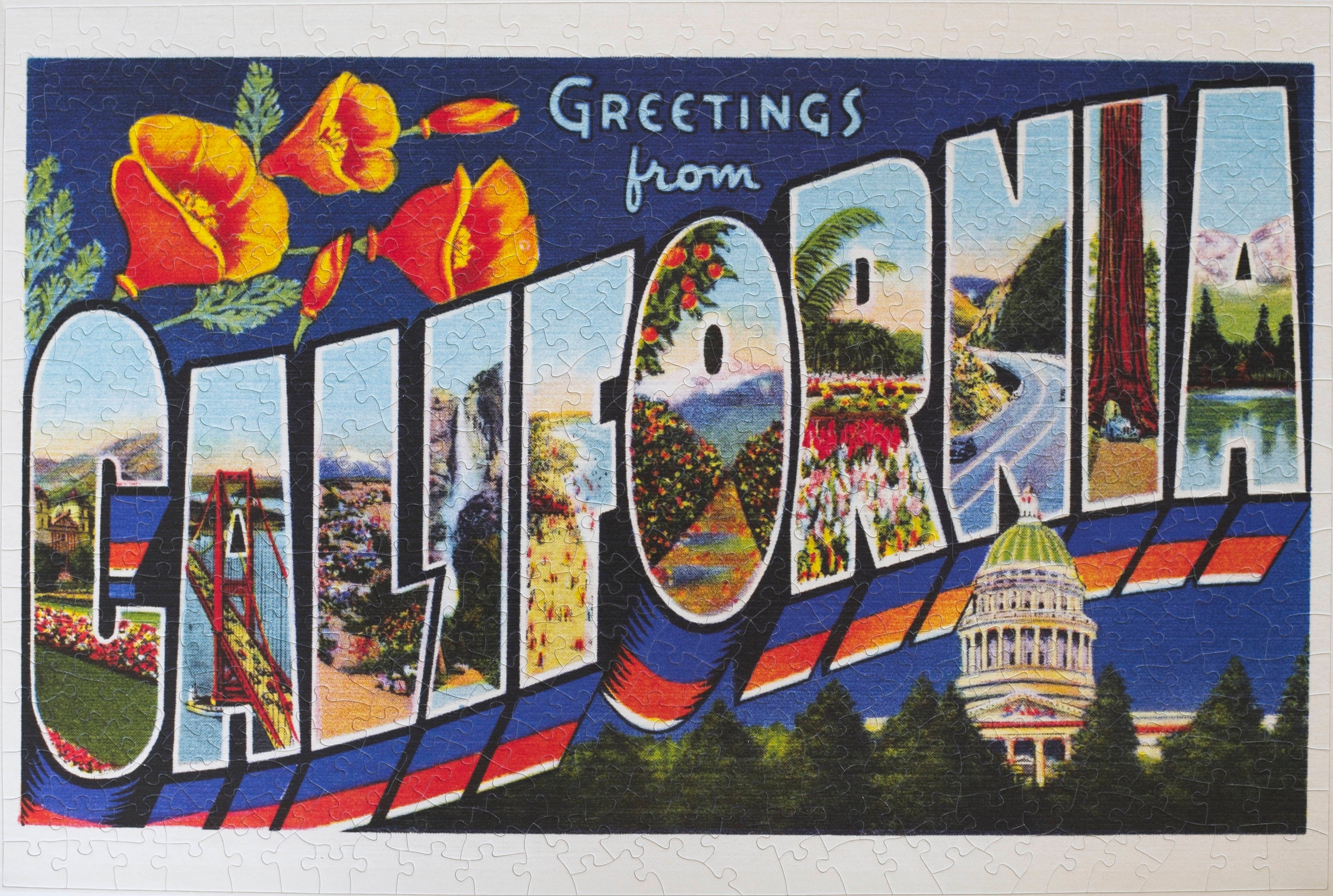 Completed Greetings from California 500-piece jigsaw puzzle showing vintage postcard art