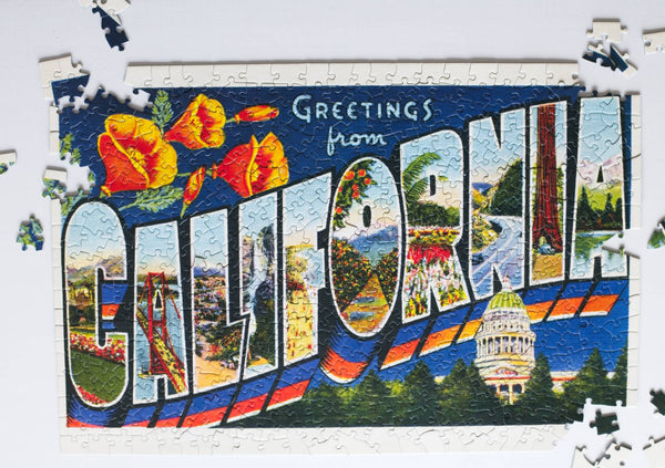 Greetings from California puzzle partially assembled on a table