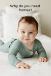 Baby in a green onesie lying on a bed with text 'Why do you need footies?'