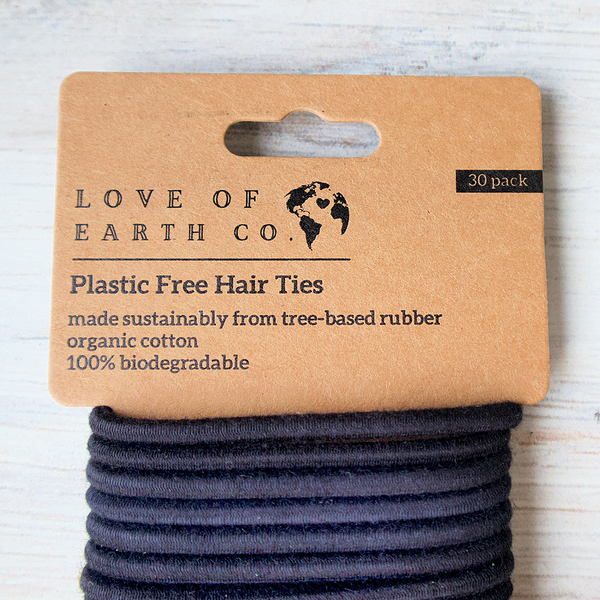 Pack of plastic-free hair ties from Love of Earth Co. on a wooden surface