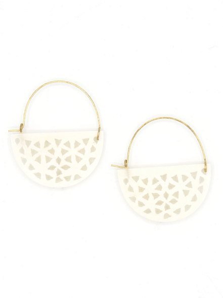 Close-up of Fair Anita upcycled bone half moon hoop earrings showing white bone and brass detail