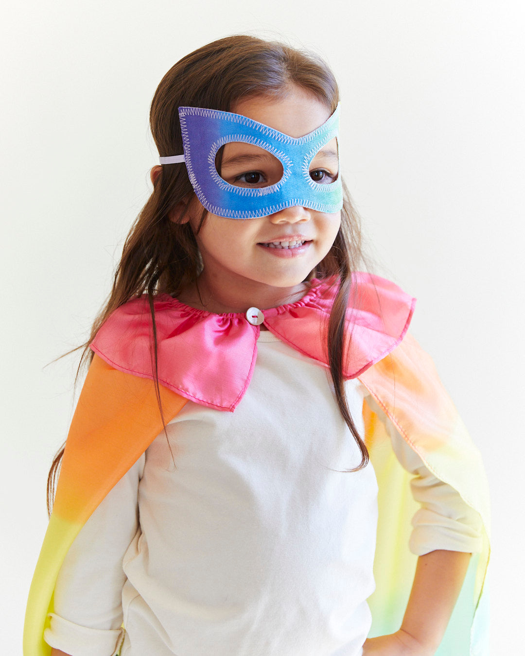 Transform your child into a fearless superhero with our Rainbow Superhero Cape and Mask Set. This vibrant costume set is perfect for dress-up adventures, Halloween, and everyday fun.