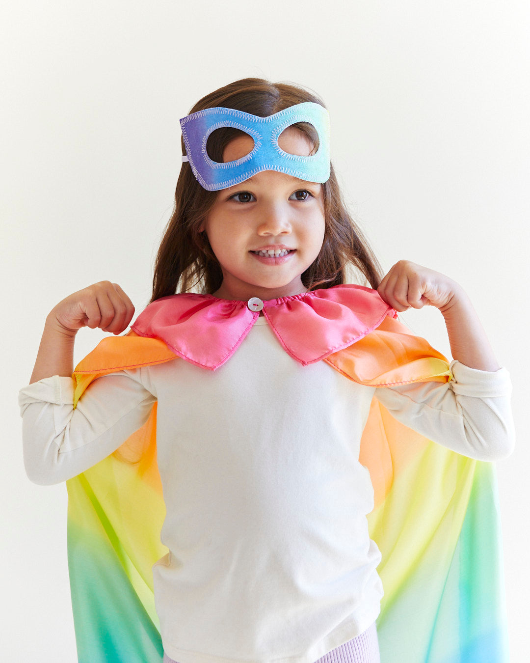 Transform your child into a fearless superhero with our Rainbow Superhero Cape and Mask Set. This vibrant costume set is perfect for dress-up adventures, Halloween, and everyday fun.