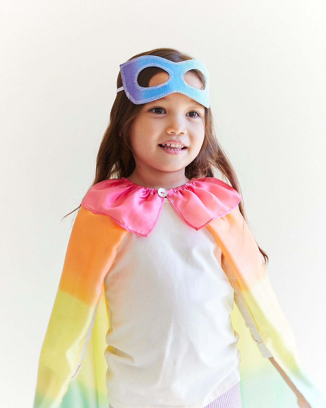 Transform your child into a fearless superhero with our Rainbow Superhero Cape and Mask Set. This vibrant costume set is perfect for dress-up adventures, Halloween, and everyday fun.