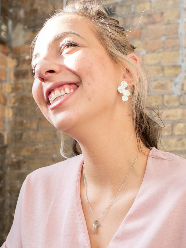 Fair Anita polka dot stud earrings styled on model showing scale and wearability
