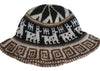 Bucket hat with black, white, and brown geometric pattern on a light background