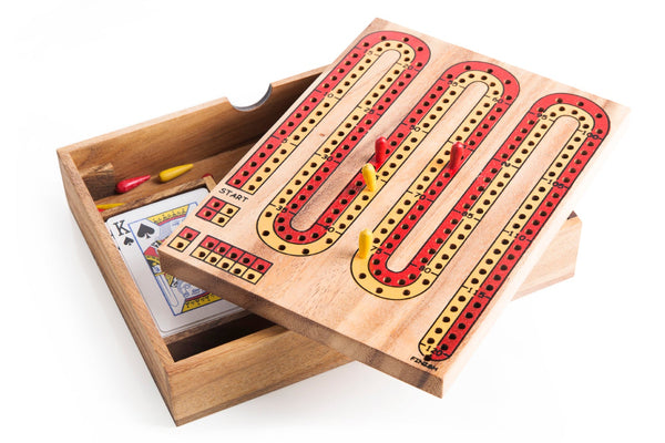Wooden cribbage board with pegs and cards on a white background