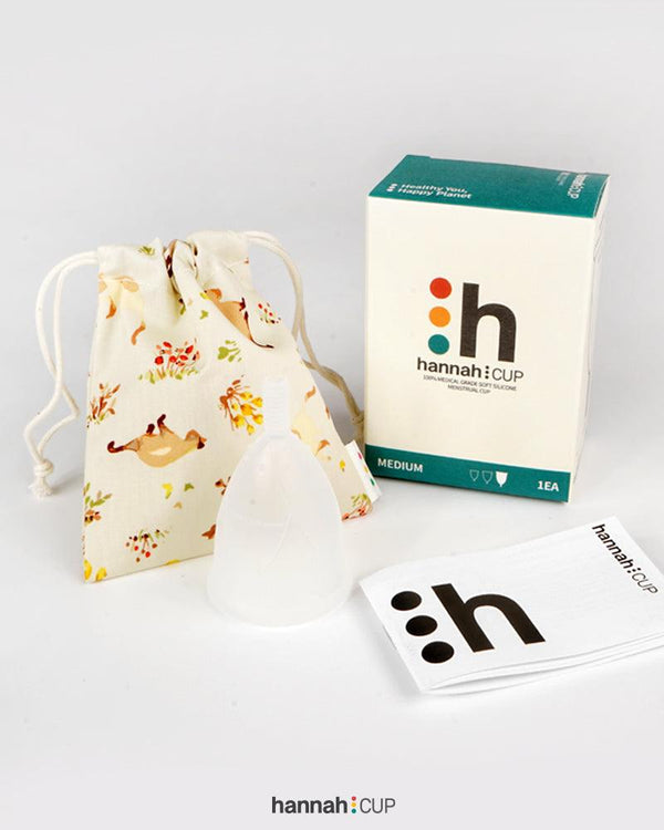 hannahCUP Medium menstrual cup shown with carry pouch and instruction booklet