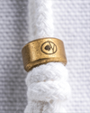Detail shot of Hayden Hill logo embossed on brass slider closure of organic cotton dust bag