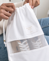 Close-up of branded brass slider and organic cotton draw cord on a Hayden Hill dust bag