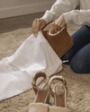 Placing ankle boots into a Hayden Hill medium organic cotton dust bag