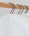 Wooden hanger with metal hooks on a white background