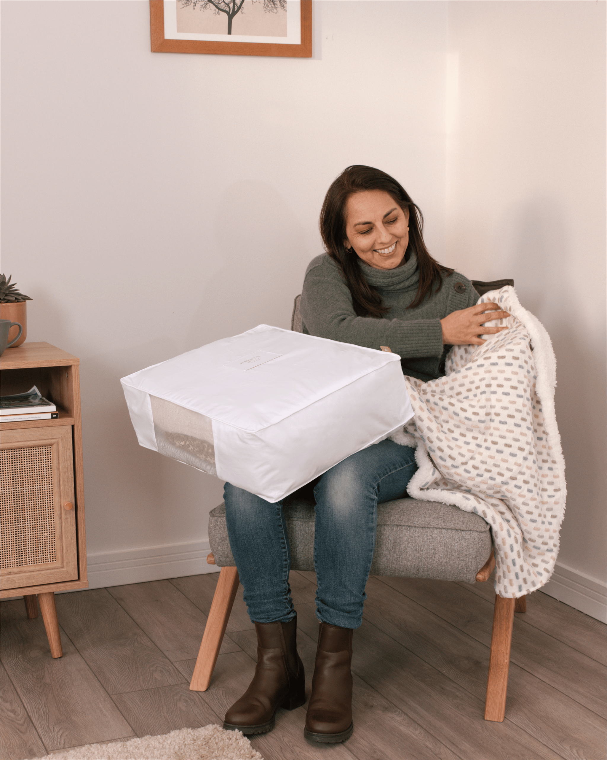 Woman holding Hayden Hill double extra large clothes storage bag on her lap