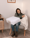 Woman holding Hayden Hill double extra large clothes storage bag on her lap