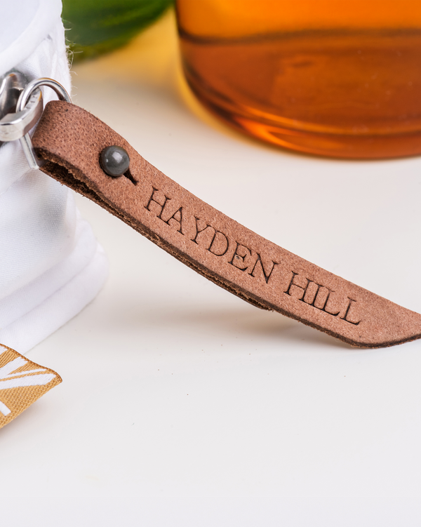 Close-up of Leather Working Group-certified zipper pull detail on Hayden Hill storage bag