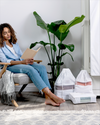 Hayden Hill large organic cotton dust bags lifestyle shot with woman seated in styled room
