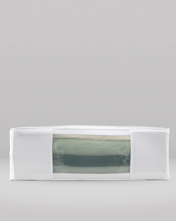 Side profile view of Hayden Hill double extra large organic cotton storage bag filled with clothes