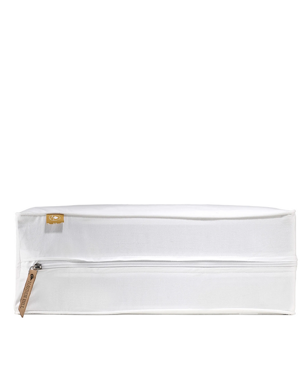 White pouch with a gold zipper on a gray background