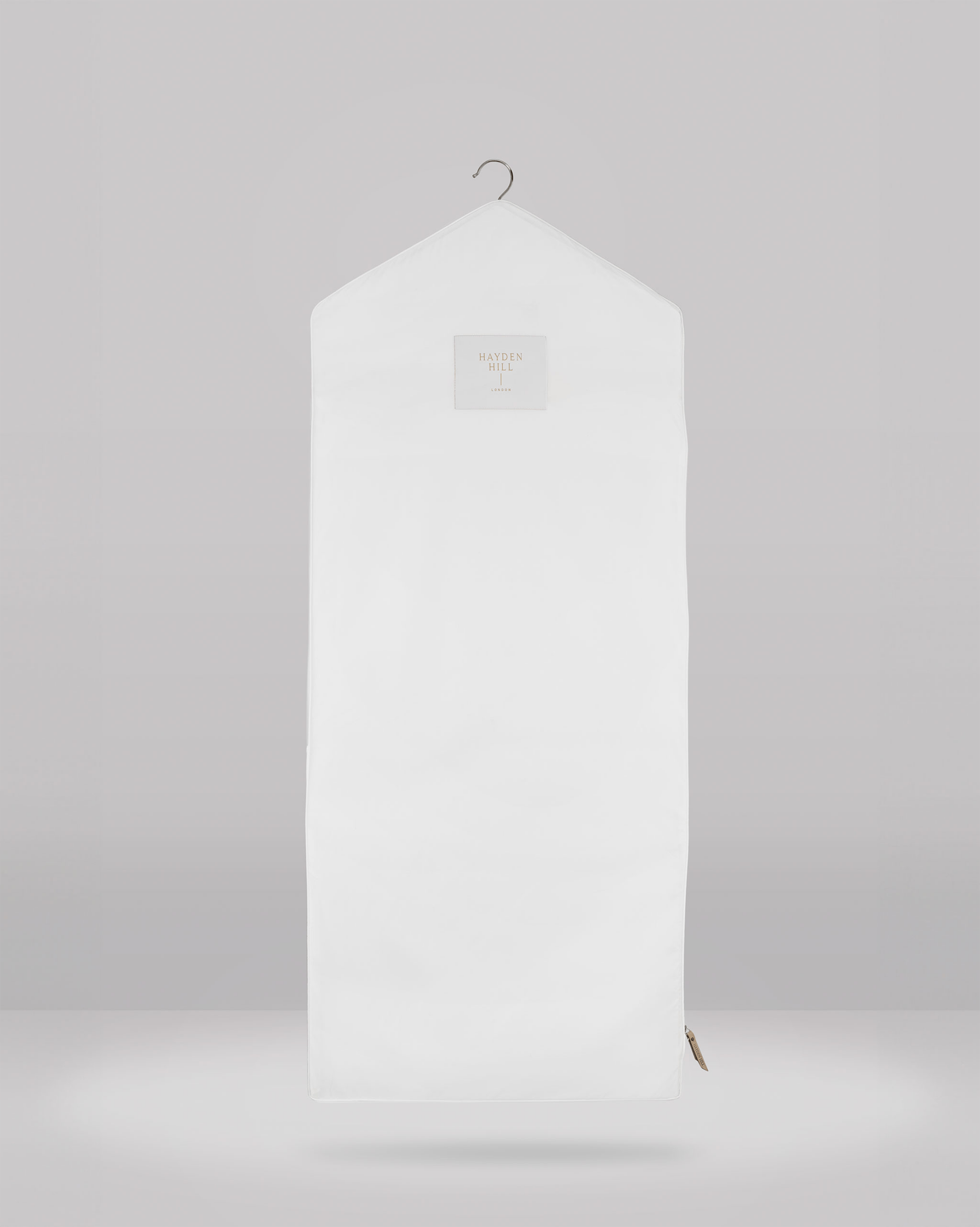 White hanging garment bag on a gray background