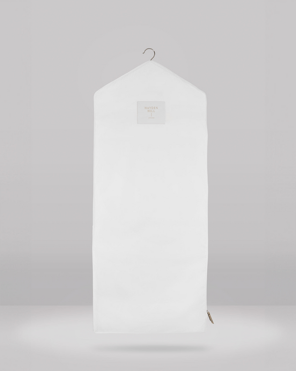 White hanging garment bag on a gray background