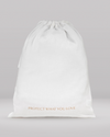 White drawstring bag with 'PROTECT WHAT YOU LOVE' text on a gray background