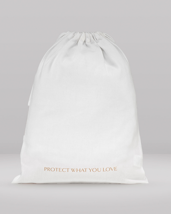 White drawstring bag with 'PROTECT WHAT YOU LOVE' text on a gray background
