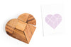 Wooden heart-shaped puzzle with a geometric heart design on a white background