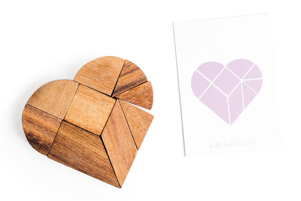 Wooden heart-shaped puzzle with a geometric heart design on a white background