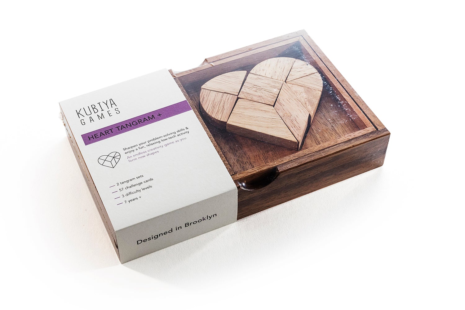 Wooden heart puzzle game in a box with packaging on a white background