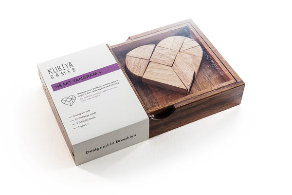 Wooden heart puzzle game in a box with packaging on a white background