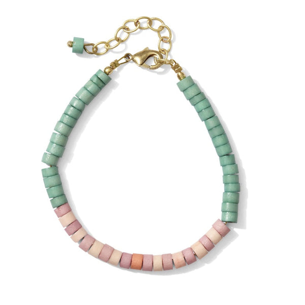 Close-up of handmade heishi bone bracelet with smooth disc-shaped upcycled bone beads and brass hardware