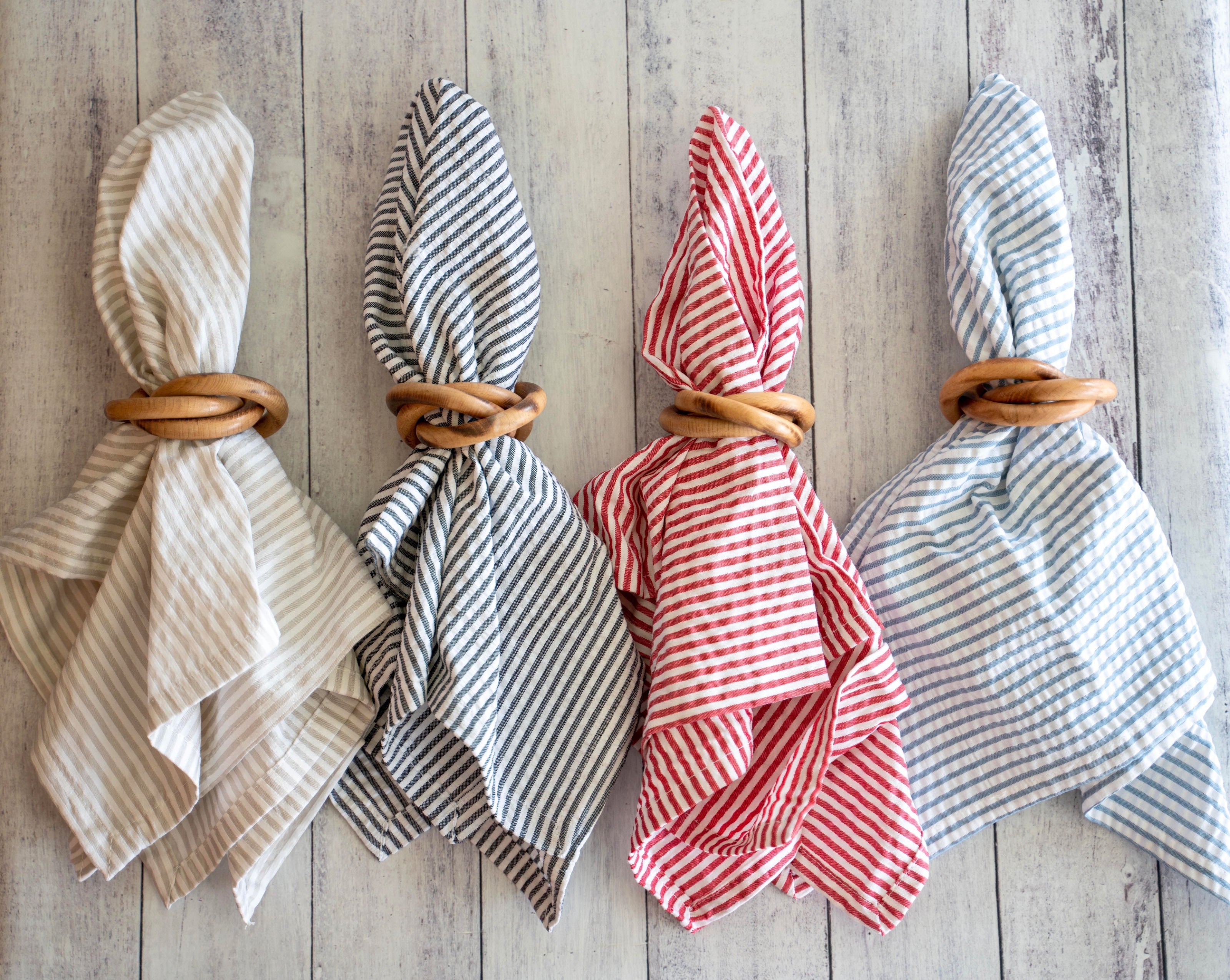 Wood bangle napkin ring paired with hemmed seersucker cloth napkins on a styled table