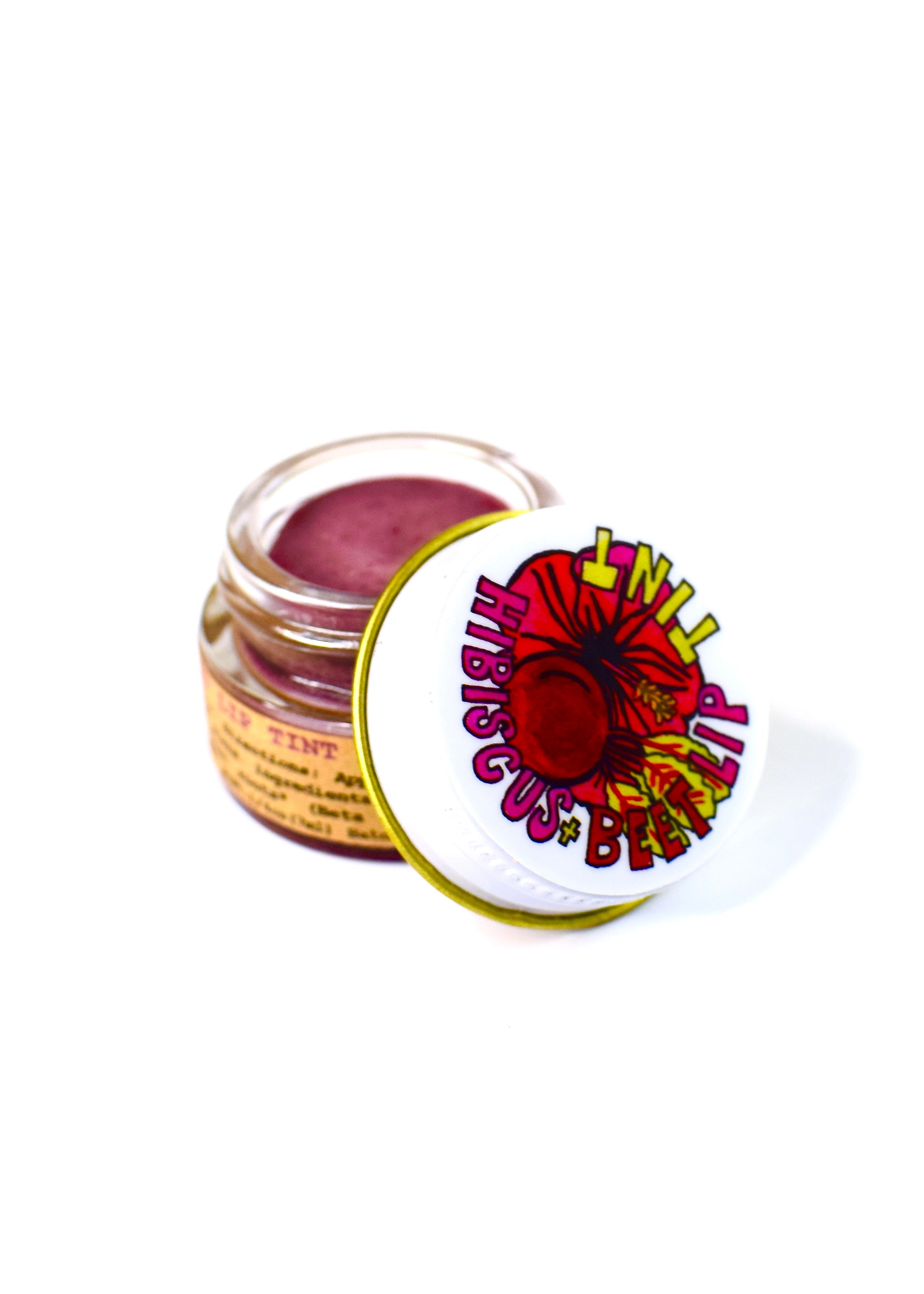 Small jar of pink cream with a colorful lid on a white background