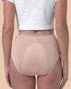 Person wearing beige underwear on a beige background