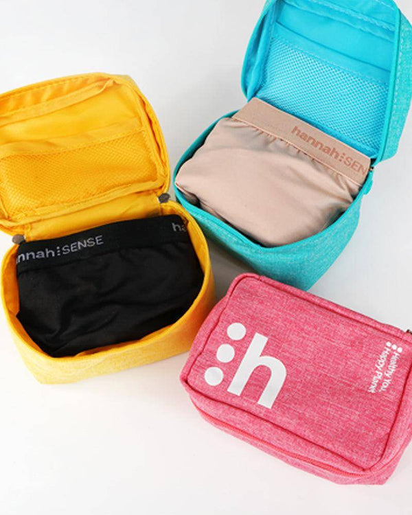 Three small pouches in yellow, blue, and pink with 'hannah:SENSE' branding on a white background.