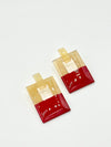 Two red and gold earring sets on a white background