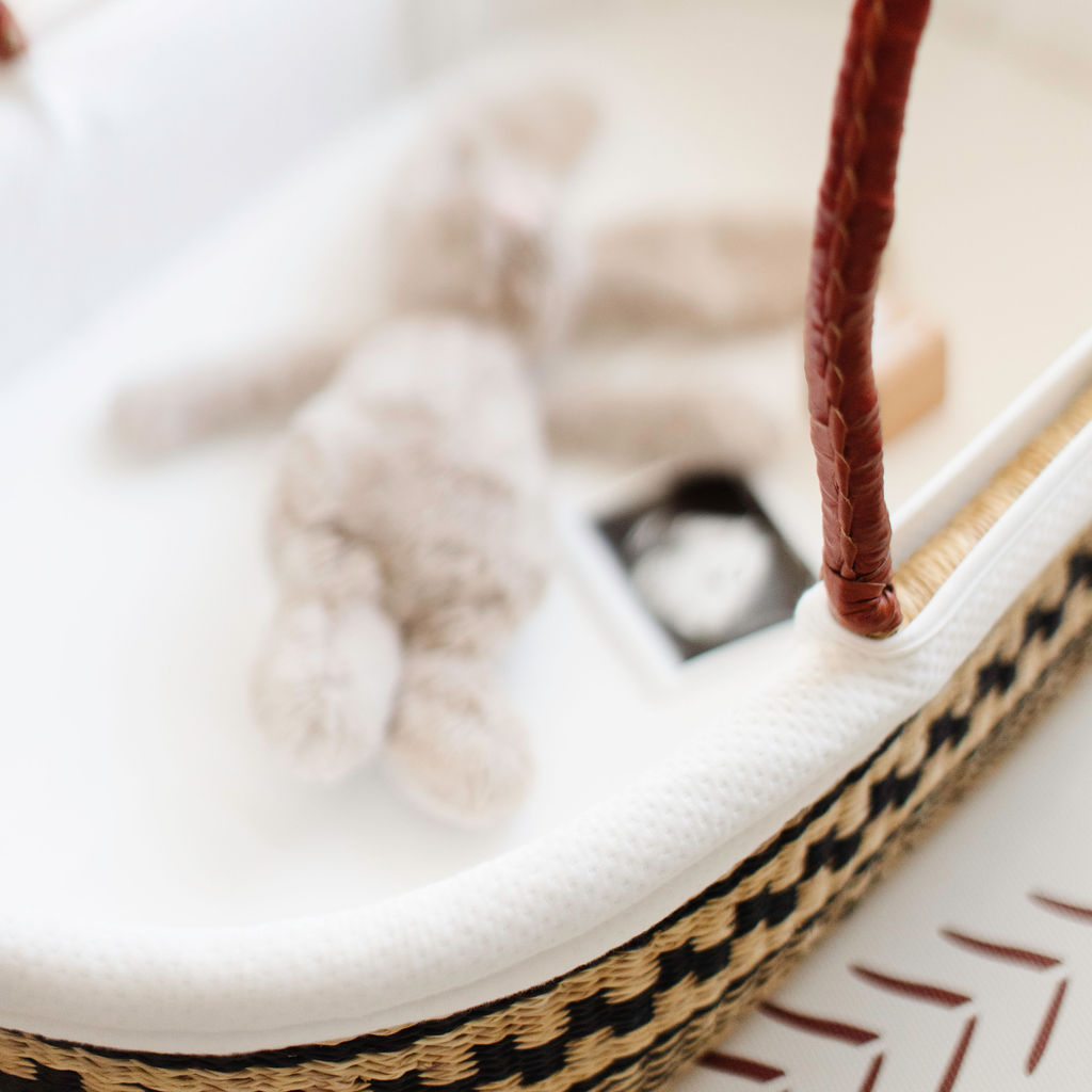 Close-up of soft cotton hood detail on Plum + Sparrow Moses basket liner