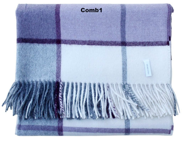 Plaid blanket with blue and white colors and fringes on a white background