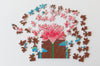 Hummingbird Spirit jigsaw puzzle partially assembled on a table