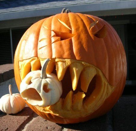 Carved Jack O' Lantern Halloween pumpkin with glowing face, grown from Seattle Seed Company Jack O' Lantern seeds